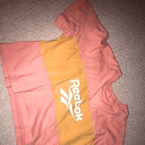 Adorable cropped Reebok top! Pairs cute with anything ! Peach and yellow. Med.